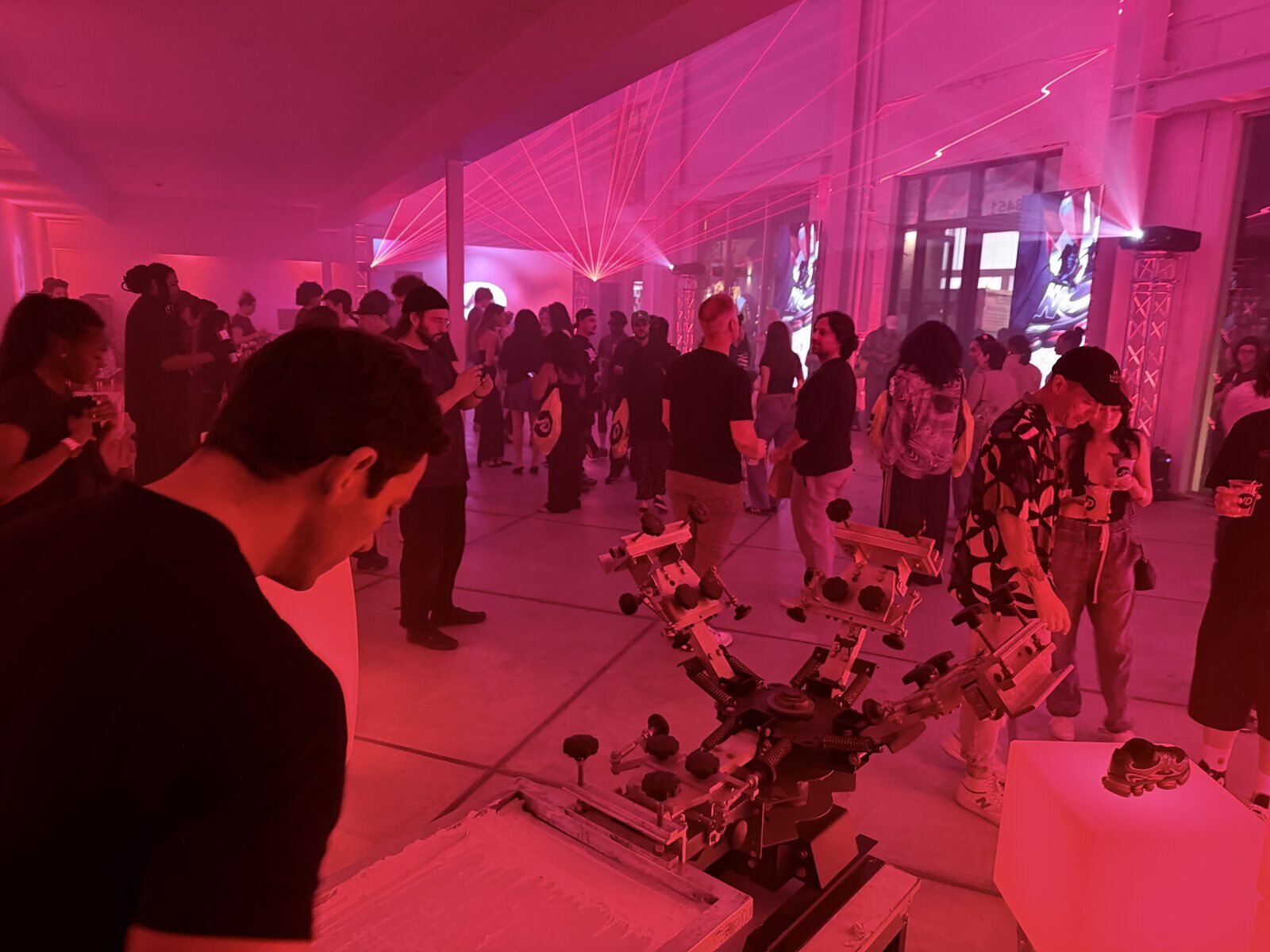 Live station busy during a pink-lit late-night celebration